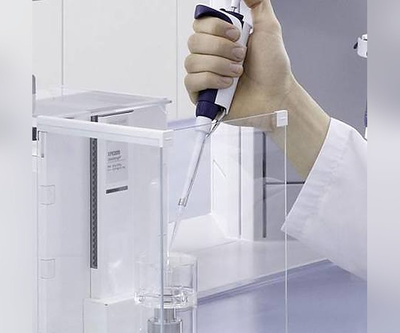 Technician at UltraCal's Bangalore calibration lab performing volumetric calibration with a micropipette